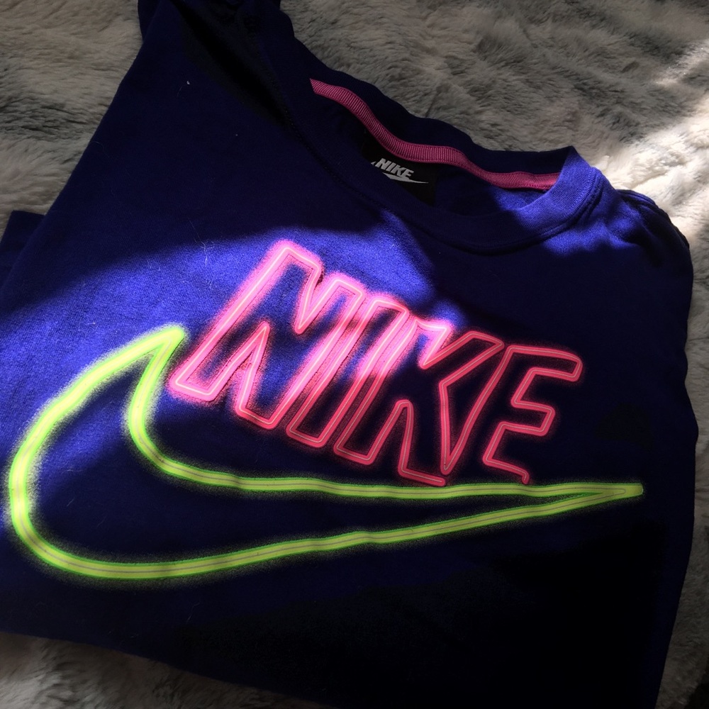 purple crop top with a neon Nike symbol